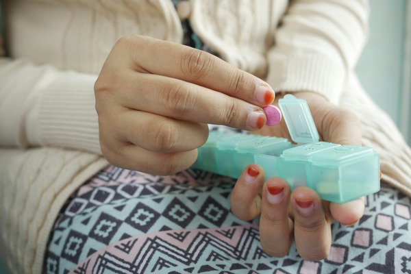 woman organizing medication assisted treatment medications