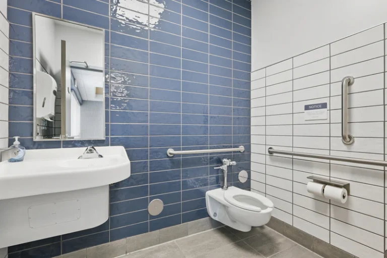 Modern bathroom with blue tiled walls.