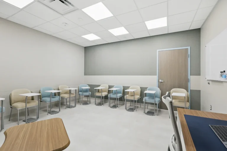 Empty consultation room with chairs and desks.