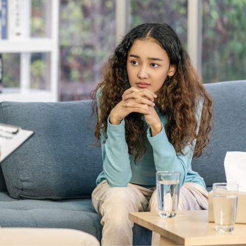A young woman listening to her mental health therapist