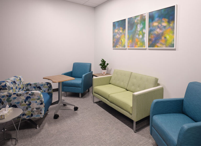 Private therapy room with seating and calming artwork