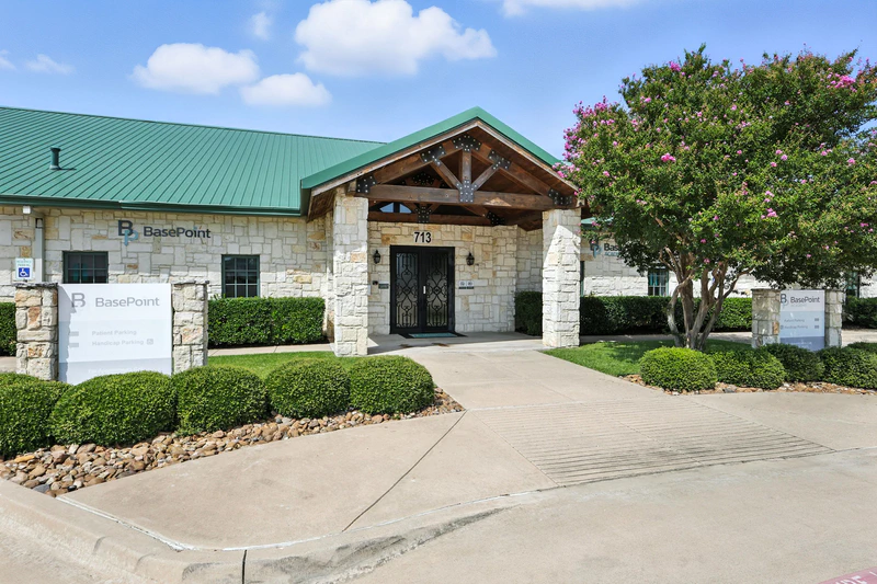 basepoint academy forney teen mental health facility entryway with bushes 1