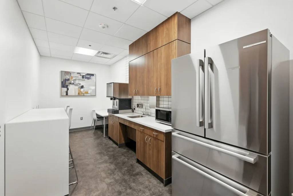 Modern kitchen with stainless appliances and brown cabinets.