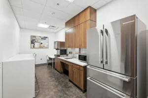 Modern kitchen with stainless appliances and brown cabinets.