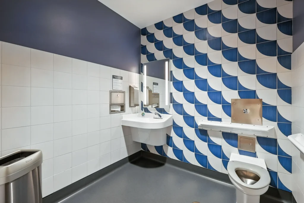 Modern restroom with decorative tiles.