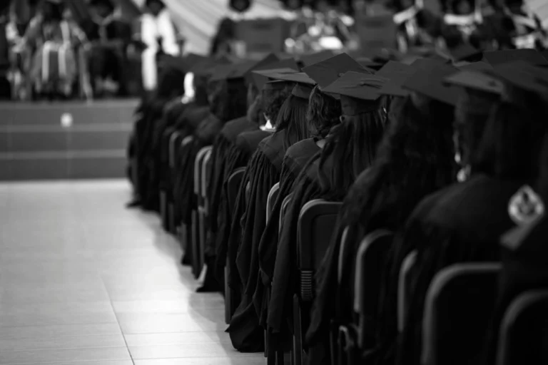 College graduation taking place with black and white filter over photo