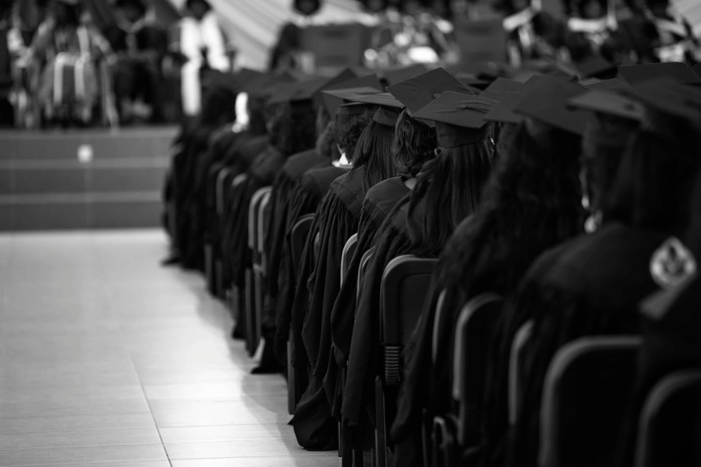 College graduation taking place with black and white filter over photo