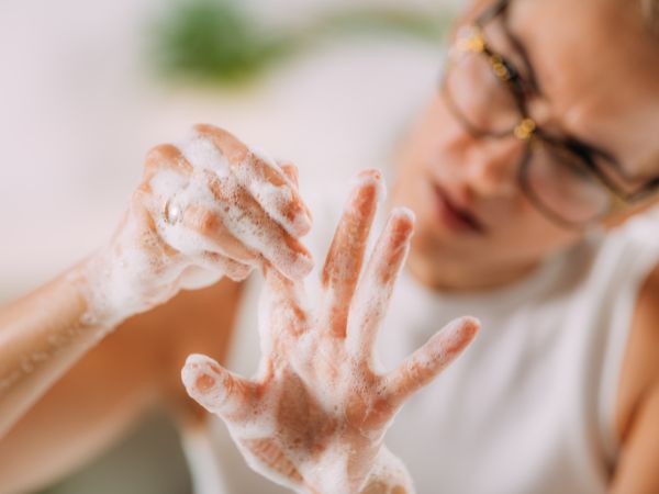 A woman with germaphobia obsessively washing her hands