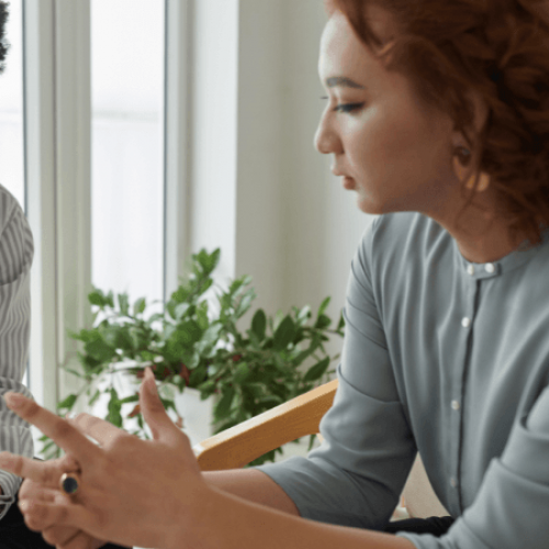 A therapist listens as a patient discusses addiction concerns