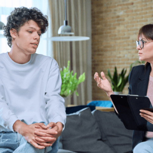 A young man and his addiction therapist talk about what to expect during a treatment program